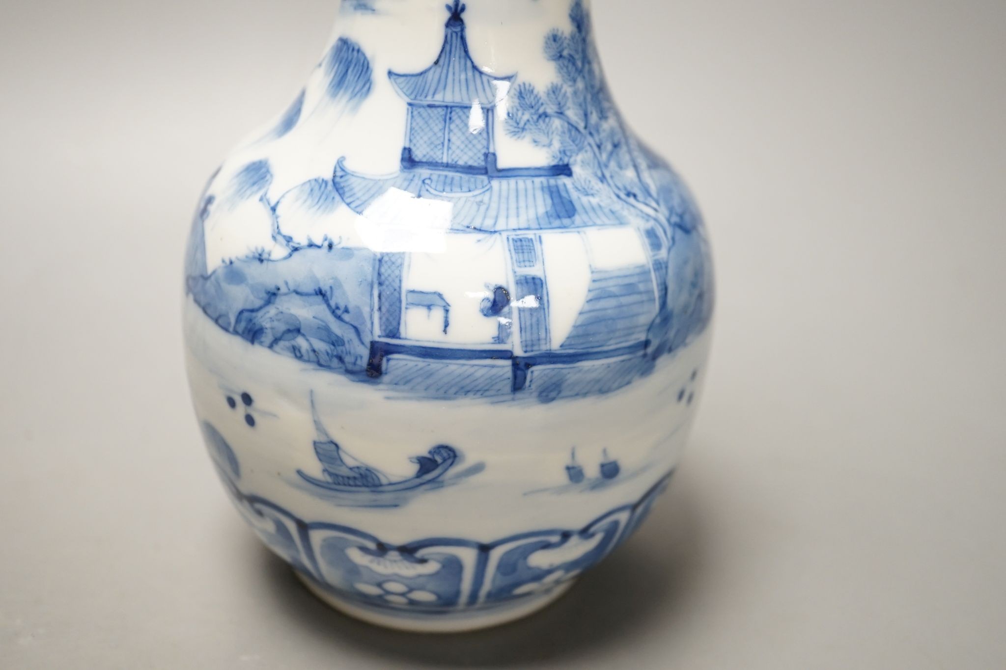 A Chinese blue and white bottle vase, Kangxi mark but 19th century. 25cm